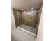 Modern bathroom with a walk-in shower, pebble floor, and rainfall showerhead at 602 Birch River Ln, Lawrenceville, GA 30043