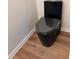 Modern bathroom with a sleek black toilet and stylish flooring at 602 Birch River Ln, Lawrenceville, GA 30043