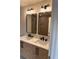 Bright bathroom featuring a double sink vanity with black hardware and a luxurious marble countertop at 602 Birch River Ln, Lawrenceville, GA 30043