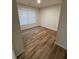 Inviting bedroom showcasing gleaming hardwood floors and a bright, airy atmosphere with a large window at 602 Birch River Ln, Lawrenceville, GA 30043