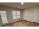 Bright bedroom with wood flooring, white trim, and a window with blinds at 602 Birch River Ln, Lawrenceville, GA 30043