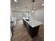 Spacious kitchen island with sink, dishwasher, and modern pendant lighting at 602 Birch River Ln, Lawrenceville, GA 30043