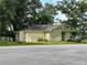 Quaint one-story home with a gable roof, lattice facade, and surrounded by mature trees on an overgrown lot at 1891 Bennett Rd, Grayson, GA 30017