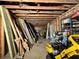 Unfinished interior featuring exposed studs, wood planks, and tools, revealing the space's potential for customization at 1891 Bennett Rd, Grayson, GA 30017