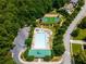 Aerial view of pool and basketball court surrounded by mature trees and parking lot at 450 Hunt Creek Dr, Acworth, GA 30101