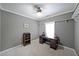 Bedroom with a gray wall, a wooden desk, and natural lighting creating a cozy atmosphere at 450 Hunt Creek Dr, Acworth, GA 30101