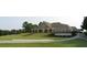 Clubhouse with outdoor seating on a manicured lawn next to a curved driveway at 450 Hunt Creek Dr, Acworth, GA 30101