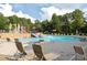 Community pool area with waterslides, fountains, lounge chairs, and colorful play structures at 450 Hunt Creek Dr, Acworth, GA 30101