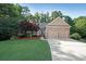 Charming single-story home boasts a manicured lawn, two-car garage, and inviting entrance with lush landscaping at 450 Hunt Creek Dr, Acworth, GA 30101