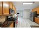 Modern kitchen featuring stainless steel appliances, granite countertops, and tile flooring at 450 Hunt Creek Dr, Acworth, GA 30101