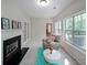 Cozy sitting room with fireplace and view of the landscaped yard at 450 Hunt Creek Dr, Acworth, GA 30101