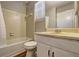 Bathroom featuring a shower-tub combo, toilet, and single sink vanity at 5026 Brittany Dr, Stone Mountain, GA 30083