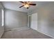 Bedroom featuring neutral walls, carpet flooring, ceiling fan and closet for storage at 5026 Brittany Dr, Stone Mountain, GA 30083