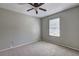 Cozy bedroom with neutral carpet, ceiling fan, and natural light from window at 5026 Brittany Dr, Stone Mountain, GA 30083