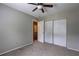 Bedroom featuring a ceiling fan, closet with sliding doors, and an open doorway at 5026 Brittany Dr, Stone Mountain, GA 30083