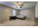 Bedroom with neutral walls, carpet flooring, ceiling fan, and desk by the window at 5026 Brittany Dr, Stone Mountain, GA 30083