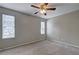 Bedroom with neutral walls, carpet, ceiling fan, and large windows with exterior views at 5026 Brittany Dr, Stone Mountain, GA 30083