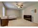 Bedroom showcasing neutral walls, ceiling fan, carpet flooring, desk, and large TV at 5026 Brittany Dr, Stone Mountain, GA 30083