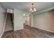 Dining room with stairs, chandelier, and vinyl flooring at 5026 Brittany Dr, Stone Mountain, GA 30083