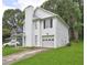Charming home with white siding, attached garage, and well-manicured lawn at 5026 Brittany Dr, Stone Mountain, GA 30083