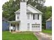 Charming two-story home with a well-manicured lawn and a classic white exterior at 5026 Brittany Dr, Stone Mountain, GA 30083