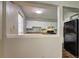 View of the kitchen featuring white cabinetry, mosaic backsplash, and black appliances at 5026 Brittany Dr, Stone Mountain, GA 30083