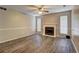 Spacious living room features a cozy fireplace and modern wood-look flooring at 5026 Brittany Dr, Stone Mountain, GA 30083