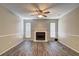 Open living room with wood-look floors, ample natural light, and a view of the fireplace at 5026 Brittany Dr, Stone Mountain, GA 30083