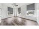 Spacious bedroom with hardwood floors, ceiling fan, and large windows offering city views at 57 Forsyth Nw St # 16G, Atlanta, GA 30303