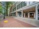 Exterior view of building entrance along street featuring brick sidewalk and large windows at 57 Forsyth Nw St # 16G, Atlanta, GA 30303