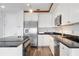 Bright kitchen features stainless steel appliances, black countertops and white cabinets at 57 Forsyth Nw St # 16G, Atlanta, GA 30303