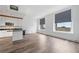 Modern living room with hardwood floors, neutral paint, and a partial kitchen view at 57 Forsyth Nw St # 16G, Atlanta, GA 30303