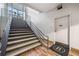 Interior stairwell with metal handrails and a closed door at 57 Forsyth Nw St # 16G, Atlanta, GA 30303