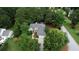 Aerial view of a single-Gathering home surrounded by mature trees and lush landscaping at 1248 Rockview Ct, Loganville, GA 30052