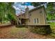 Backyard featuring a multi-level deck, stone retaining wall, and lush, green landscaping at 1248 Rockview Ct, Loganville, GA 30052