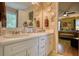 Bathroom with double sinks, a large mirror, and decorative plates, adding a touch of elegance to the space at 1248 Rockview Ct, Loganville, GA 30052