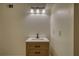 Bathroom vanity featuring wood cabinets, white countertop, black faucet, and modern three light fixture at 1248 Rockview Ct, Loganville, GA 30052