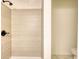 Bright bathroom with beige tile shower, bronze fixtures and black accents with an attached toilet area at 1248 Rockview Ct, Loganville, GA 30052