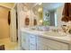Bathroom featuring double sinks, decorative plates, and a spacious layout, offering comfort and style at 1248 Rockview Ct, Loganville, GA 30052