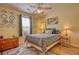 Bright bedroom with ceiling fan, area rug, and natural light from the window at 1248 Rockview Ct, Loganville, GA 30052