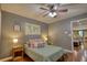 Cozy bedroom with gray walls, striped bedding, and a hardwood floor, adjacent to a dining area at 1248 Rockview Ct, Loganville, GA 30052