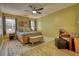 Comfortable bedroom with natural light, a ceiling fan, and carpeted floors, providing a relaxing retreat at 1248 Rockview Ct, Loganville, GA 30052