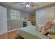 This gray bedroom showcases a window, area rug, and closet space for maximum storage and organization at 1248 Rockview Ct, Loganville, GA 30052