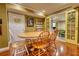 Dining area with wood table and chairs, featuring French doors and connection to an adjacent room at 1248 Rockview Ct, Loganville, GA 30052