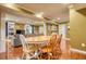 Open dining area connecting to living room, featuring wood table and chairs, and hardwood flooring at 1248 Rockview Ct, Loganville, GA 30052