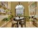Well-lit dining room with plants, a chandelier, and a rustic table, creating a cozy and inviting atmosphere at 1248 Rockview Ct, Loganville, GA 30052