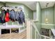 View of the entryway with green walls, white trim, coat rack and storage bench on the landing at 1248 Rockview Ct, Loganville, GA 30052