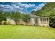 A well-maintained single-Gathering home with lush landscaping and a charming outdoor patio at 1248 Rockview Ct, Loganville, GA 30052