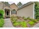 View of front exterior, with an inviting garden featuring lush plants adding to the curb appeal at 1248 Rockview Ct, Loganville, GA 30052