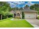 Charming one-story home featuring a manicured lawn, attached two-car garage, and inviting front porch at 1248 Rockview Ct, Loganville, GA 30052